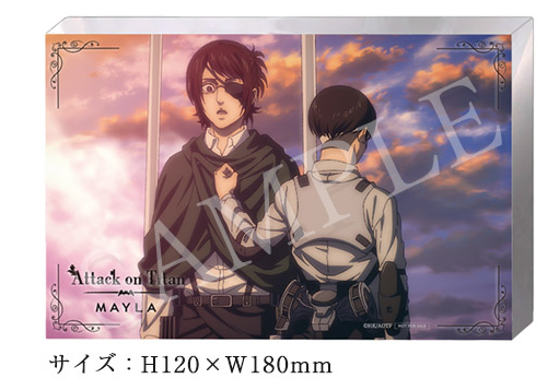 An acrylic block showing the characters Hange and Levi that is provided as a gift with a pair of shoes inspired by the character Hange Zoe from the anime series Attack on Titan.