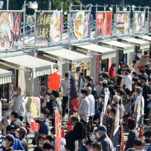 Ramen stalls with people waiting in line at Tokyo Ramen Festa