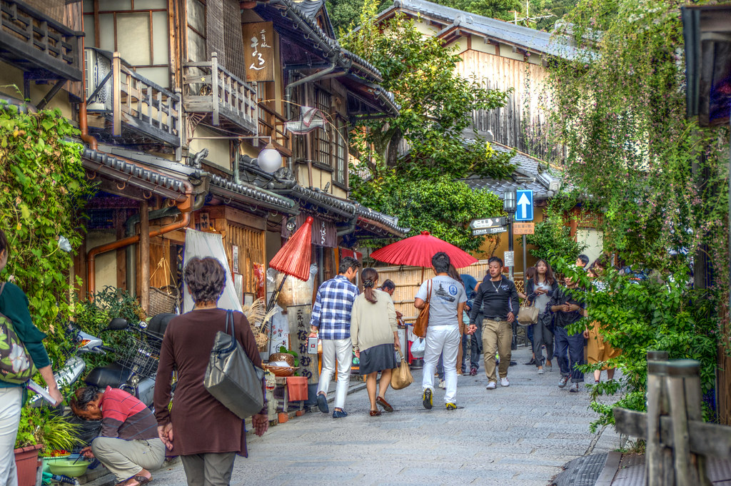 Tourists walking down a traditional street in Kyoto