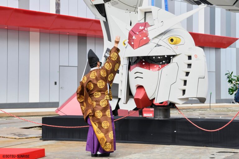 Shinto priest blessing the head of the Gundam statue