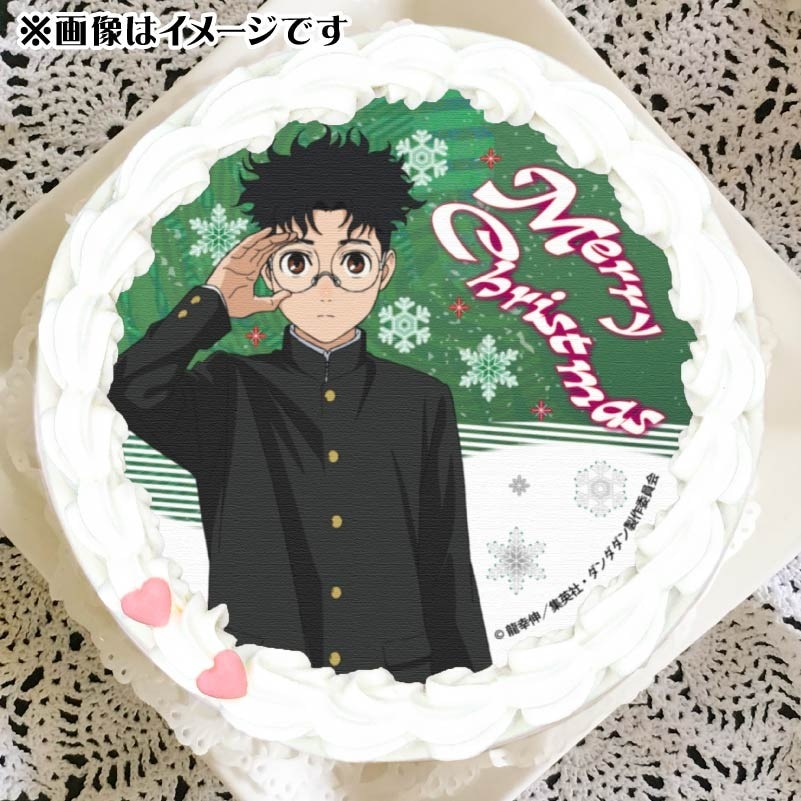 A Dandadan themed Christmas cake featuring Okarun