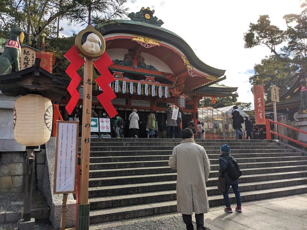 Worshippers praying at Fushimi Inari Shrine