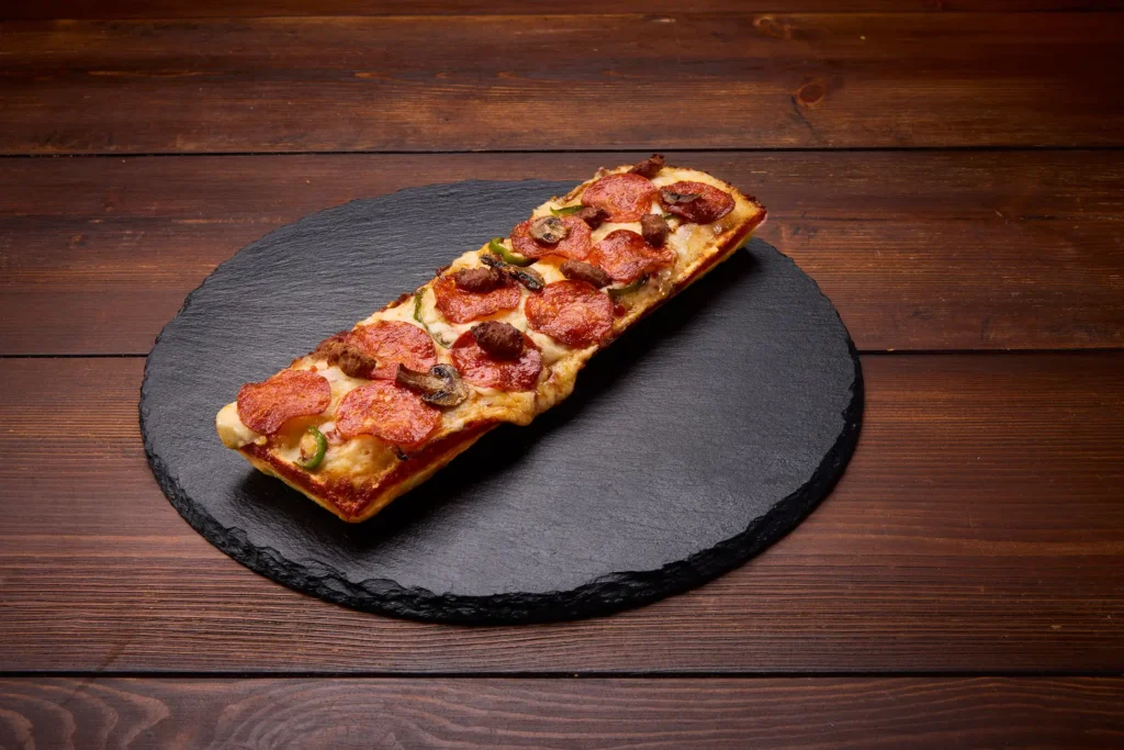 A pizza on a stone plate