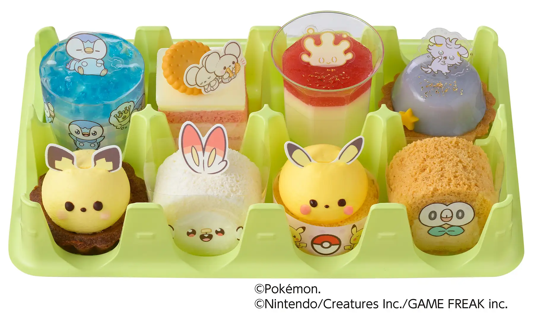A tray containing 8 different cakes inspired by Pokemon characters A tray containing 8 different cakes inspired by Pokemon characters