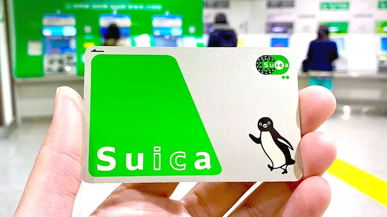 Suica card held up in a train station in Japan