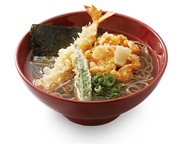 A bowl filled with noodles, broth and a selection of tempura