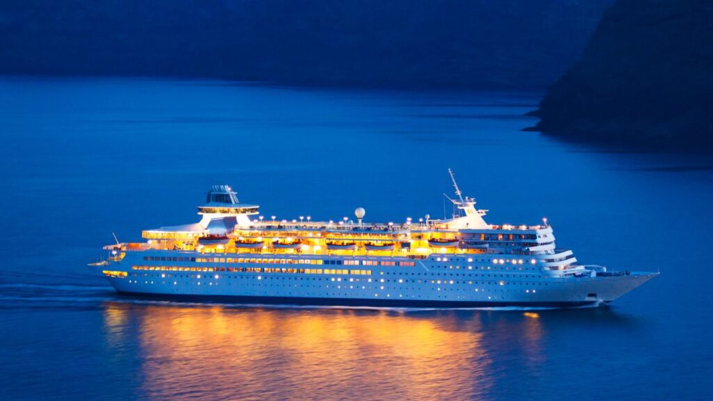 A cruise ship in open water at night