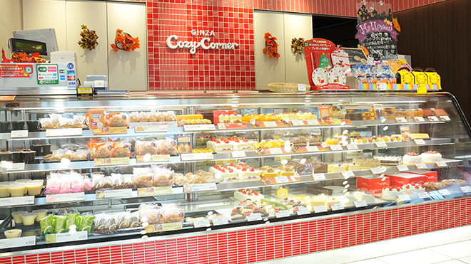 An image of the main counter in a Ginza Cozy Corner store containing a variety of cakes and baked goods