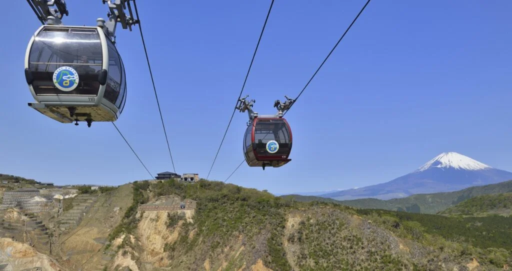 Two gondolas travelling on the Hakone Ropeway in Hakone, Japan