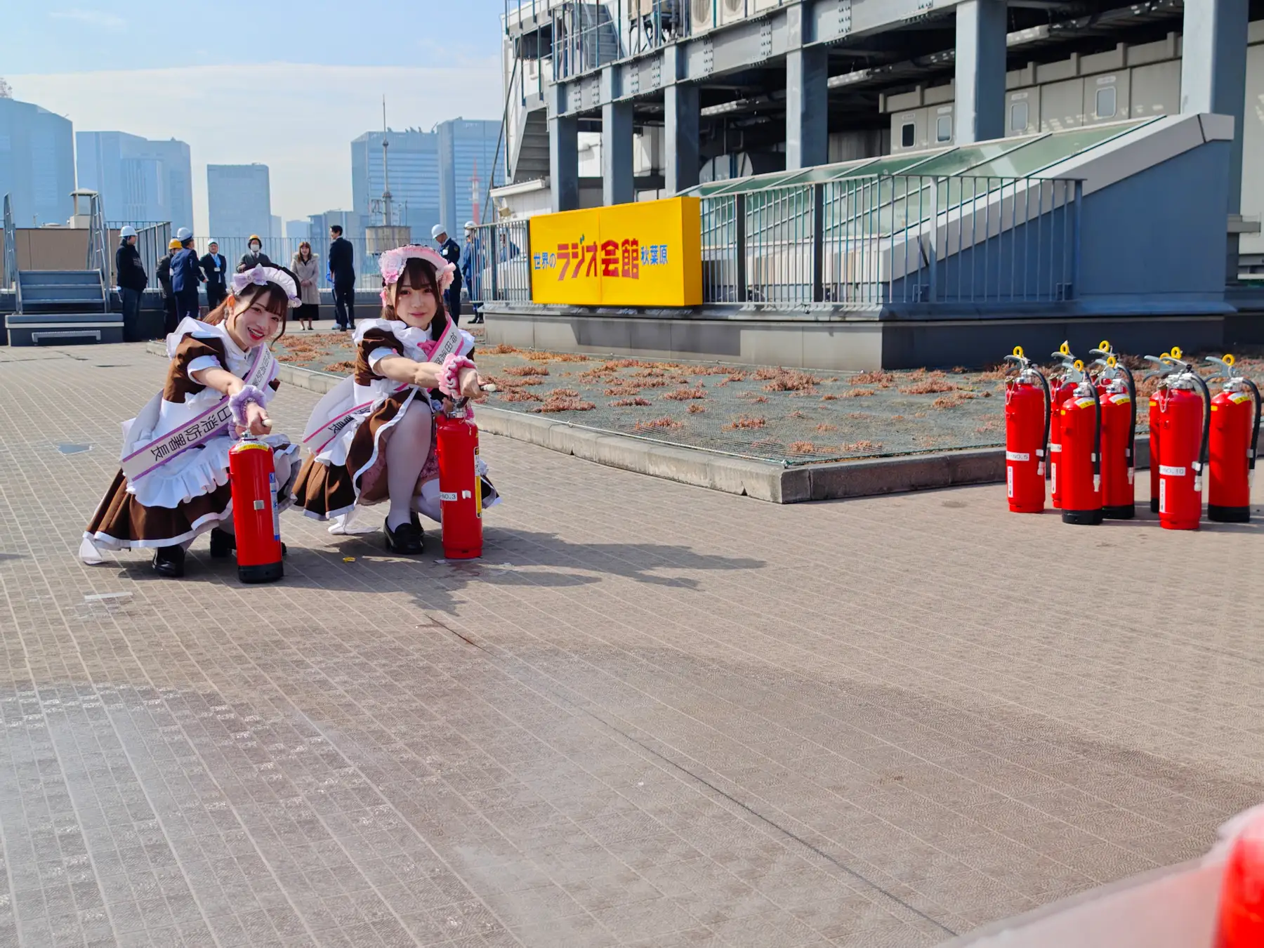 Two maid using fire extinguishers Two maid using fire extinguishers