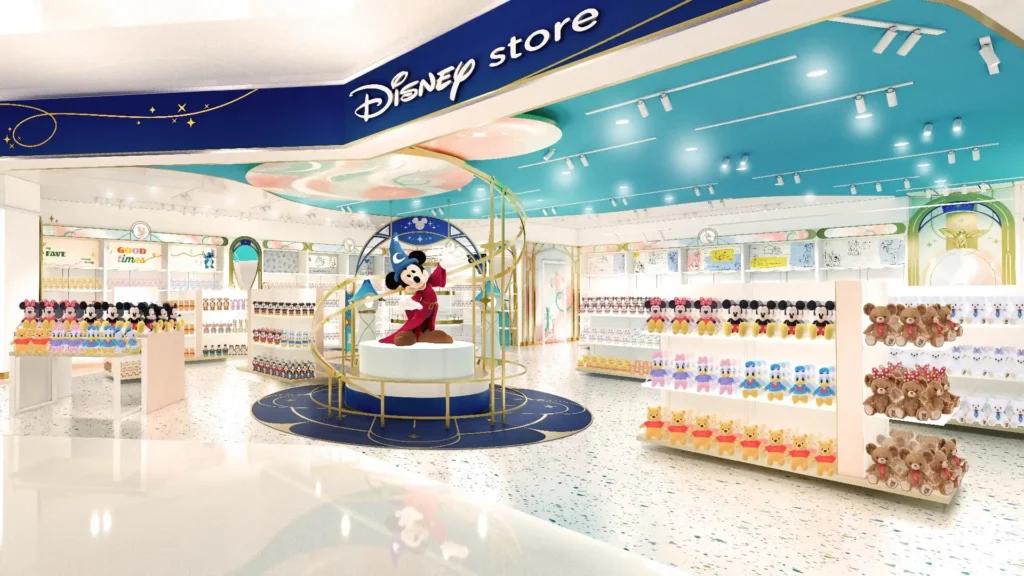 A store featuring a large statue of Mickey Mouse dressed as the sorcerers apprentice and shelves holding Disney toys