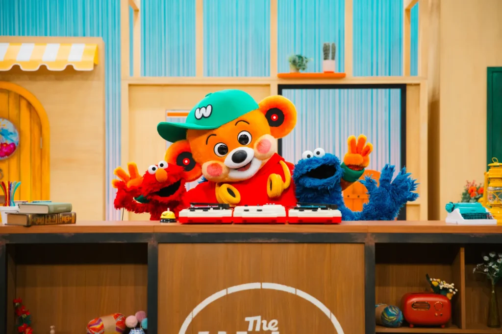 Three puppets next to each other: Elmo, DJ Wakey and Cookie Monster