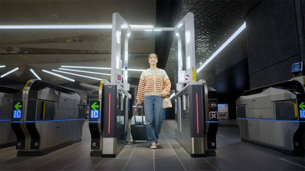 A woman walking through a facial recognition ticket gate